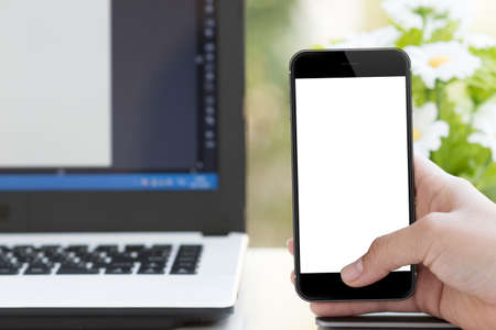 mockup phone in woman hand on deskの写真素材