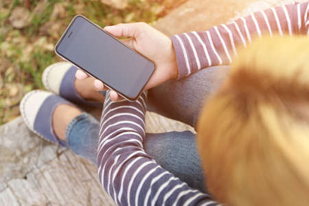 hipster female holding smart phone modern technologyの写真素材
