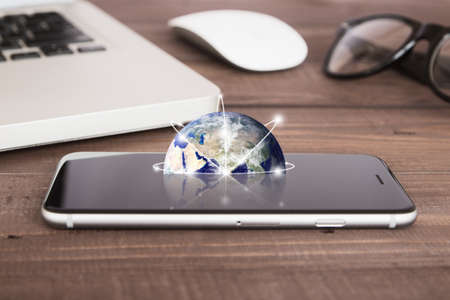 earth on phone screen network concept elementsの写真素材