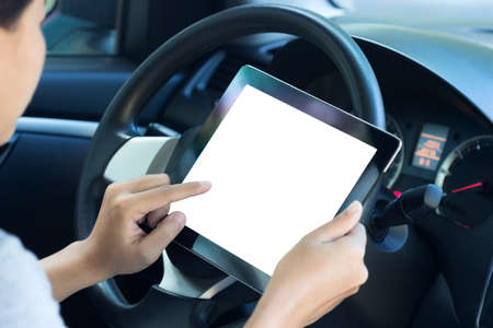 closeup women using tablet inside car