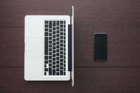 phone and laptop computer on table top viewの写真素材