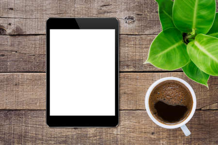 digital tablet on wood table top view, tablet white screen for adjust app screenの写真素材