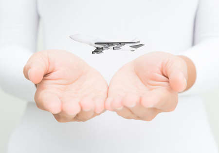 airplane in woman hand transport conceptの写真素材