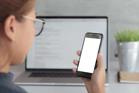 close-up woman holding phone and looking blank screen in office workplace