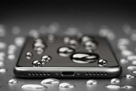 close-up phone be waterproof shot on black backgroundの写真素材