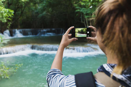 tourism use smartphone taking photographの写真素材