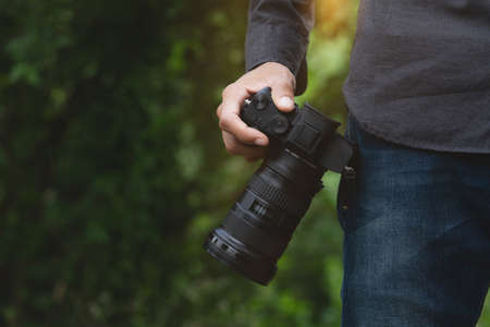 close-up on photographer hand holding camera