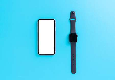 smartphone and smart watch on light blue backgroundの写真素材