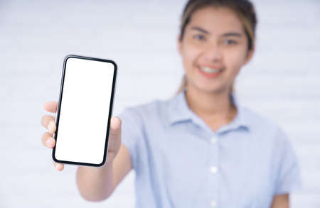smile women holding phone showing white screenの写真素材