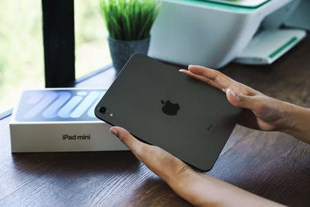 Bangkok, Thailand - October 1, 2021: Close up hand opening box of new ipad mini gen 6 order from apple store onlineのeditorial素材
