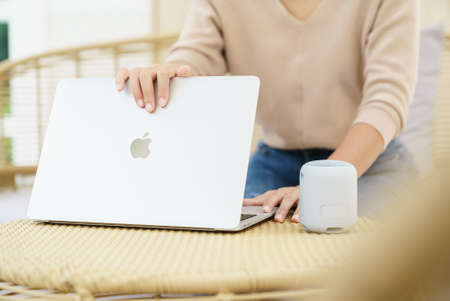 Bangkok, Thailand - October 7, 2021: Close up women hand using Apple Macbook air on table. Macbook air is product of Apple inc.のeditorial素材