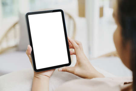 woman using digital tablet rear view shotの写真素材