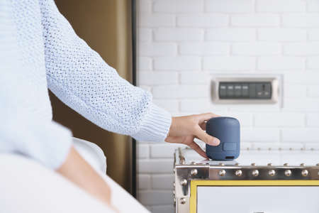 close-up on portable wireless speaker in hand on table, new technology speaker easy to use