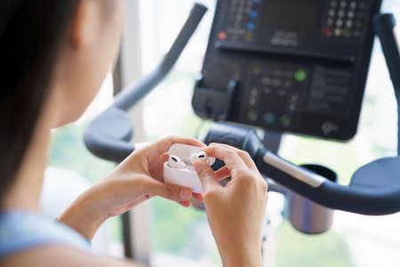 sport woman using wireless headphone in gym sport clupの写真素材
