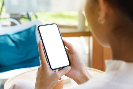 A women holding phone showing white screenの写真素材