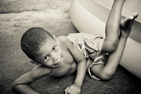 a boy falls out of an inflatable poolの写真素材