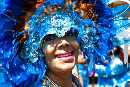 Trinidad, West Indies - February 5, 2008 - Smiling female masquerader with headdress taking part in...