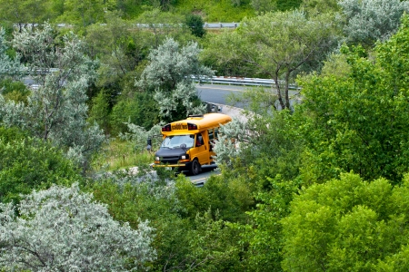 school bus on highway off-ramp in summertimeの写真素材