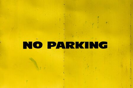 no parking sign on a yellow metal gateの写真素材