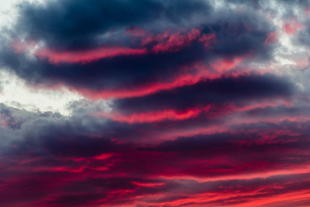 mysterious fiery sky at sunset with altocumulus cloudsの写真素材