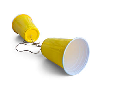 Comunication Yellow Plastic cup with string isolated on white