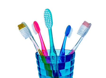Tooth brushes in a glass isolated on white backgroundの写真素材