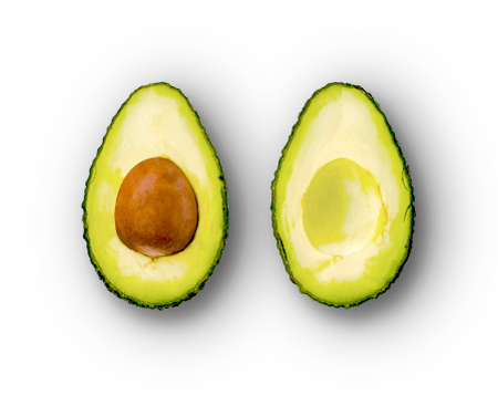 Avocado cut in half on white background