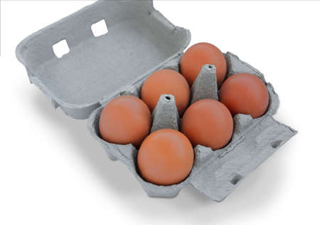 Six Brown eggs on cardboard box isolated on white background