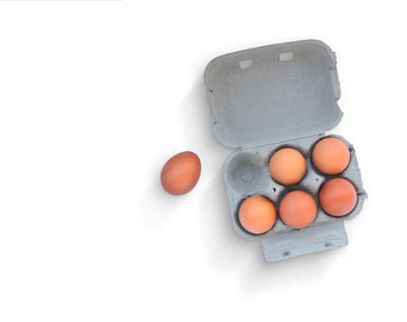 Six Brown eggs on cardboard box isolated on white background