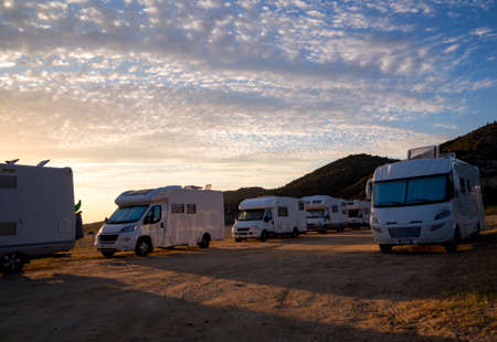 RV campers nn the beach at sunsetの写真素材