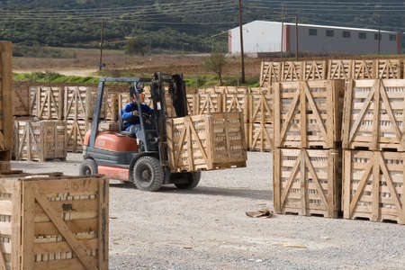 Forklift worker picking up palletの写真素材