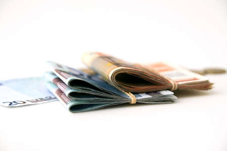 Euro banknotes and coins isolated on white backgroundの写真素材