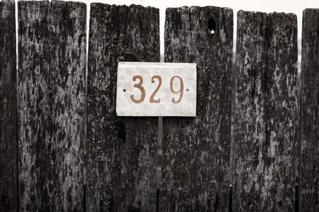 light a sign on an old wooden fence with slots