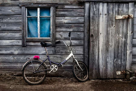 the bike against the wall of an old houseの写真素材