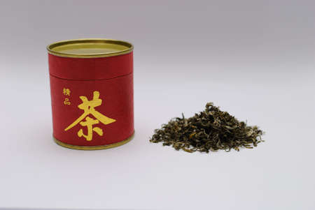 A jar of tea and green tea leavesの写真素材