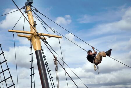 A man working on a boat's rigging.の写真素材