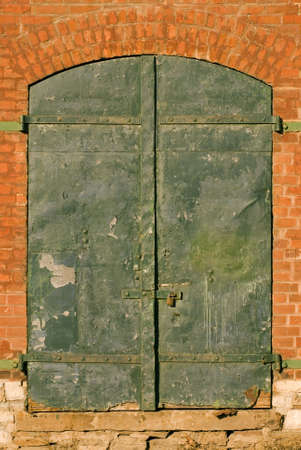 Green doors on an old warehouse.の写真素材