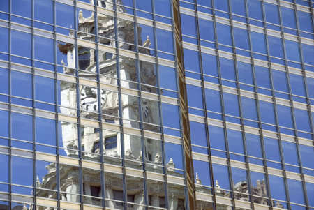 The clock of Chicago's Wrigley building reflected in a nearby office tower.の写真素材