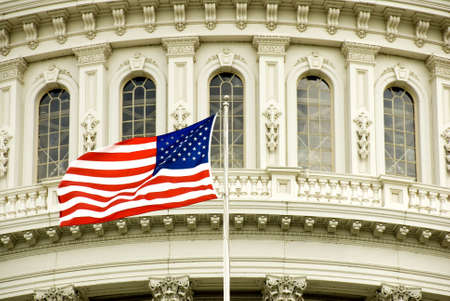 The flag of the USA flying in front of the Capitol building in Washington, DC.の写真素材