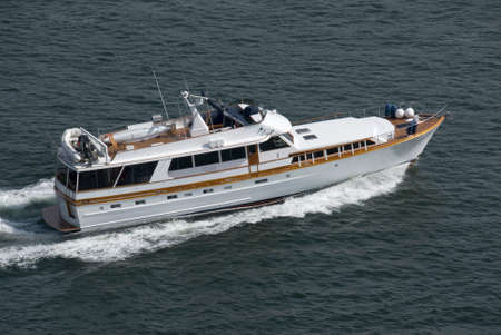 A luxury yacht travelling at speed through the Pacific.