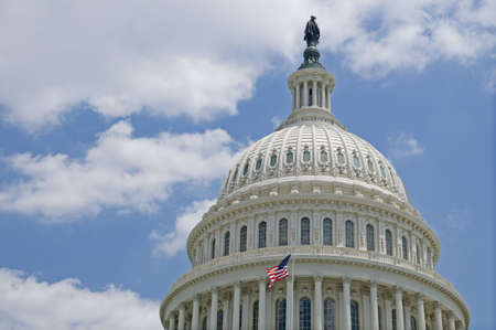 The flag of the USA flying in front of the Capitol dome in Washington, DC.の写真素材