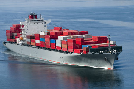 A container ship arriving in port on a very calm day.
