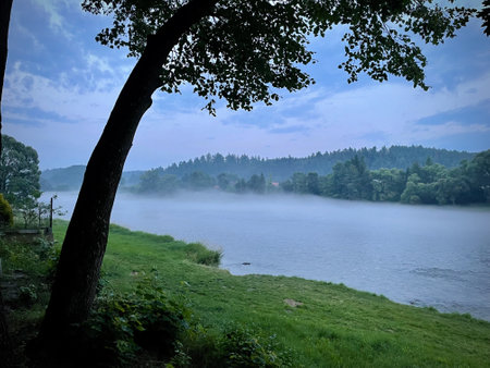 View of the fog rising above the water on the San River in Lesko.の写真素材