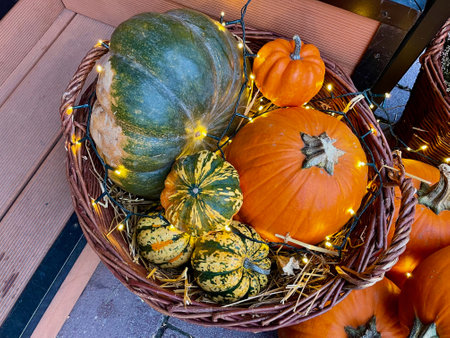 Orange and green pumpkins in a basketの写真素材