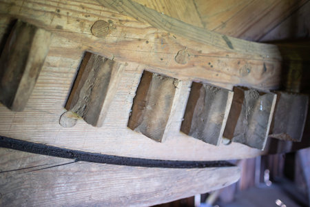 The wooden blocks are arranged in a row, with some of them being slightly crooked. The scene is somewhat disorganized and chaotic, as the blocks are not perfectly alignedの写真素材