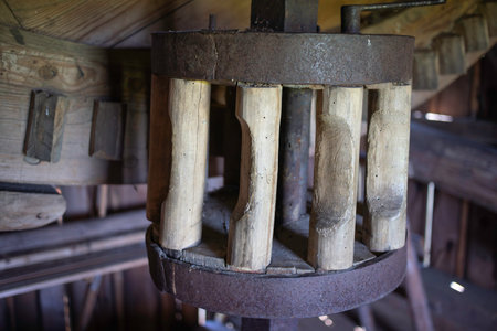 A wooden structure with a metal base and a wooden top. The structure is old and has a rustic appearanceの写真素材
