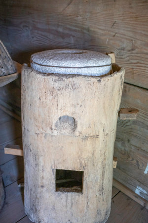 A wooden log with a hole in it. The log is old and has a rustic appearance.