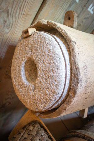 A wooden barrel with a hole in the middle. The barrel is old and has a rustic appearanceの写真素材