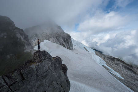 A mountain climber climbs over a glacier in BC