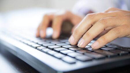 Hands typing on a keyboard